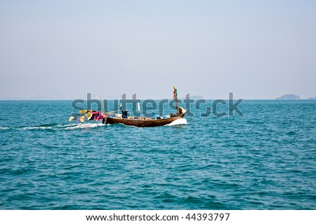 fisherman steers his small wooden boat out to the open sea to go for as catch