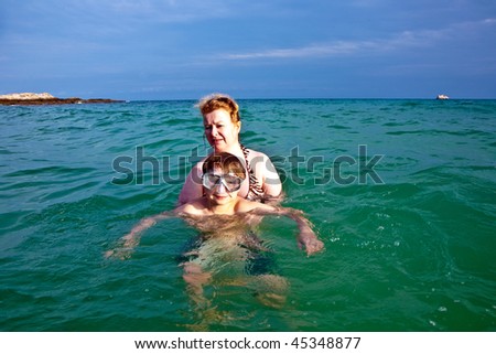 woman with red hair is enjoying the beautiful warm water in the clear sea