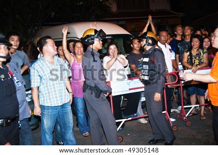 BANGKOK, THAILAND - MAY 6: Crowd and vendors of Patpong night market demonstrate as police confiscate their fake goods May 6, 2009 in Bangkok. The area is famous for selling fake goods.