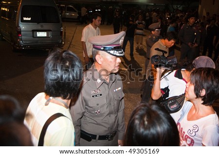 BANGKOK, THAILAND - May 6: A policeman speaks to the press during crowd and vendors of Patpong night market demonstrate when police confiscate their fake goods May 6, 2009 in Bangkok.