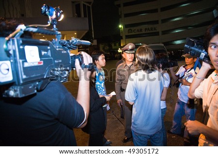 BANGKOK, THAILAND - May 6: A policeman speaks to the press during crowd and vendors of Patpong night market demonstrate when police confiscate their fake goods May 6, 2009 in Bangkok.