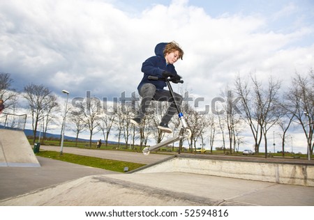 boy is going airborne with a scooter
