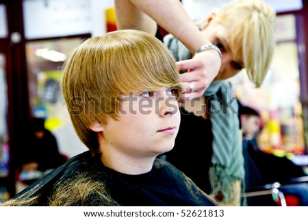 smiling young boy at the hairdresser