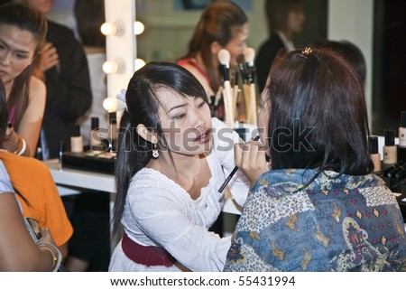 BANGKOK, THAILAND - MAY 11: cosmetic company AMWAY sponsors a makeup course with its products in the central world center and assists woman in using products, May 11, 2009 in Bangkok, Thailand