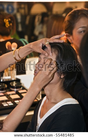 BANGKOK, THAILAND - May 11: cosmetic company AMWAY sponsored a makeup course with its products in the central world center and assists woman in using products , May 11, 2009 in Bangkok, Thailand