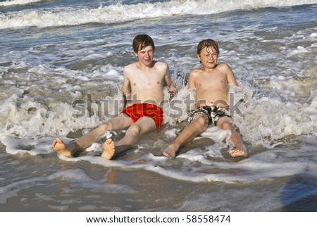 boys having fun in the beautiful clear sea