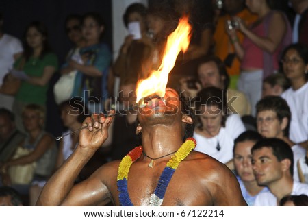 CANDY, SRI LANKA - AUGUST 12: fire dancer keeps his tongue to the torch at the  festival Pera Hera in Candy to celebrate the tooth of Buddha August 12,2005, Candy, Sri Lanka