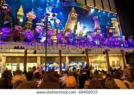 MADRID, SPAIN - DECEMBER 20: People have fun in Christmas time watching the famous puppet show and illumination at center El Corte Ingles on December 20, 2010 in Madrid, Spain.
