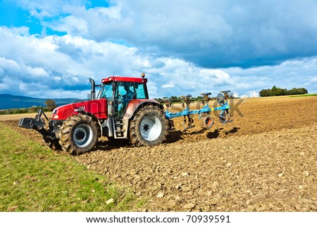 tractor with plow on field