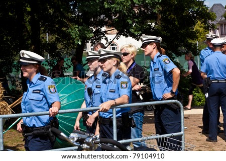 OBERURSEL, GERMANY - JUNE 12: police officers watch the show at the Hessentag on June 12, 2011 in Oberursel, Germany. Hessentag is a big festival to present a city in the county of Hesse in Germany.