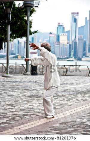 HONG KONG - JANUARY 8: Tai Chi Public Exercising in early morning at January 08, 2010 in Hongkong.  The old teacher teaches younger people to learn Tai Chi in the harbor area to keep tradition alive.