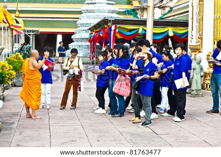 BANGKOK, THAILAND - MAY 12: buddhist monk explains the secrets of temple area Wat Pho Pho to a group of unidentified schoolers at their school excursion on May 12,2009 in Bangkok, Thailand.