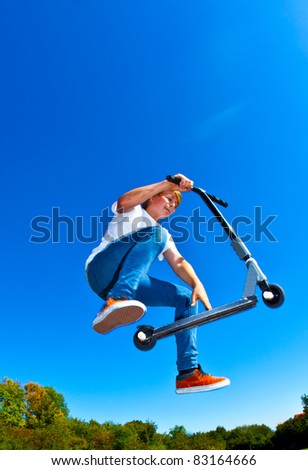 boy jumping with his scooter