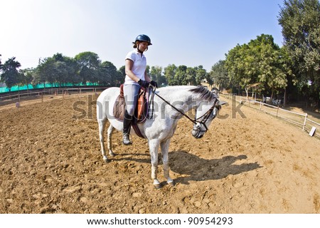 female rider trains the horse in the riding course