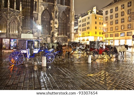 VIENNA, AUSTRIA - NOV 26:  horse drawn fiaker at the Stephans Dome  by night on November 26,2010 in Vienna, Austria. Since the 17th century, the horse-drawn carriages characterize Viennas cityscape.