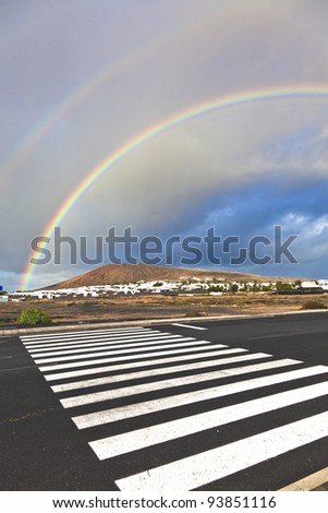 beautiful rainbow over the mountain with dark clouds