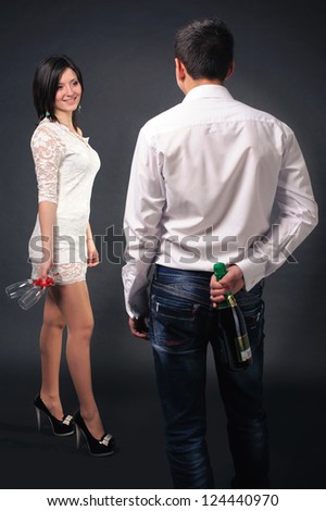 Happy young couple in love drinking champagne