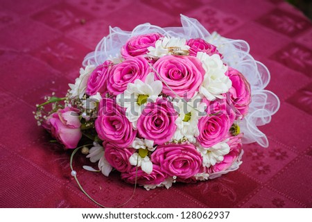 Bridal wedding bouquet of flowers. Wedding bouquet of red roses on red background.