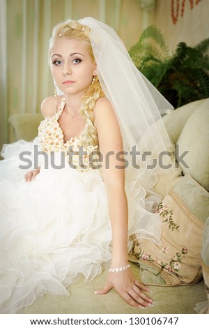 Happy young bride outside on her wedding day. Wedding couple - new family! wedding dress. Bridal wedding bouquet of flowers