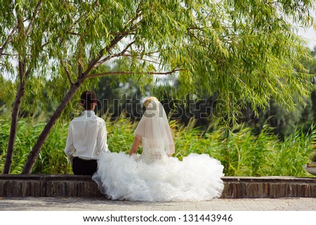 Happy young bride and groom outside on their wedding day - Copyspace. Wedding couple - new family! wedding dress. Bridal wedding bouquet of flowers