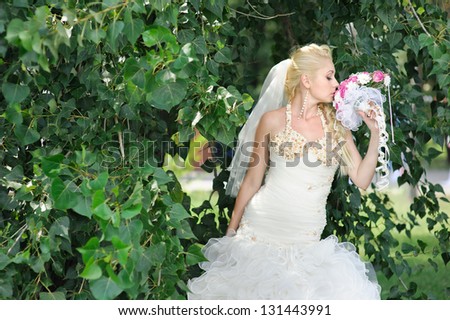 Happy young bride outside on her wedding day - Copyspace. Wedding couple - new family! wedding dress. Bridal wedding bouquet of flowers