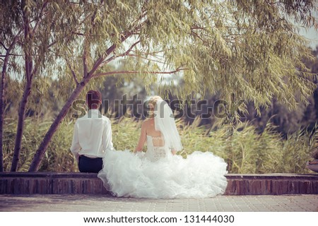 Happy young bride and groom outside on their wedding day - Copyspace. Wedding couple - new family! wedding dress. Bridal wedding bouquet of flowers