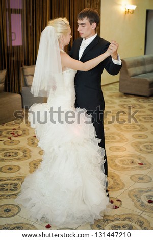 Bride and groom dancing on their wedding. Bride and groom dancing the first dance at their wedding day. dancing couple  in the restaurant - new family! wedding dress. Bridal wedding bouquet of flowers