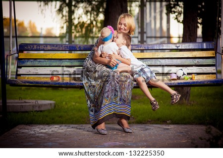Mother And Daughter In The Park. Mother And Her Child Enjoy The Early Spring. Happiness - Mother With Her Child.Young Mother With Child Outside On A Summer Day. Mother Playing With Her Son In The Park