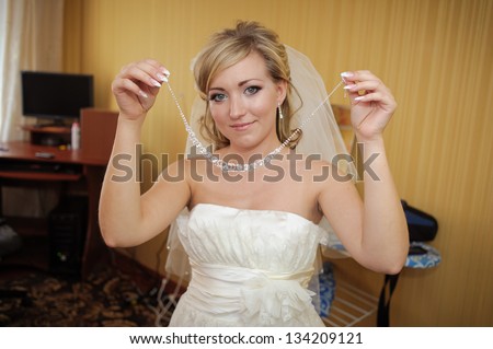 Bride dressing gown. bride preparing for a wedding. bride is getting dressed in the room. brunette young bride prepare for the event