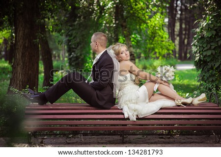 Happy young bride and groom outside on their wedding day. Wedding couple - new family! wedding dress. Bridal wedding bouquet of flowers