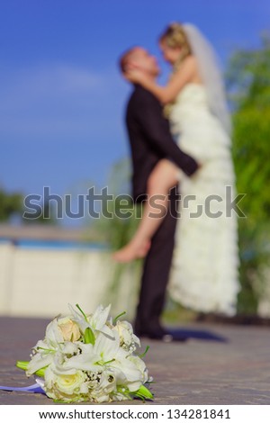 Happy young bride and groom outside on their wedding day. Wedding couple - new family! wedding dress. Bridal wedding bouquet of flowers