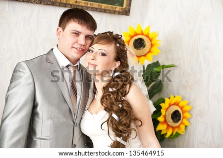 Wedding couple - new family! wedding dress. Bridal wedding bouquet of flowers. An excited bride and groom embrace each other and laughing on their wedding day