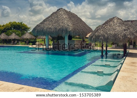 Outdoor resort pool Swimming pool of luxury hotel. Swimming pool in luxury resort near the sea. Tropical Paradise. Swimming pool in spa resort. Dominican Republic, Seychelles, Caribbean, Bahamas.