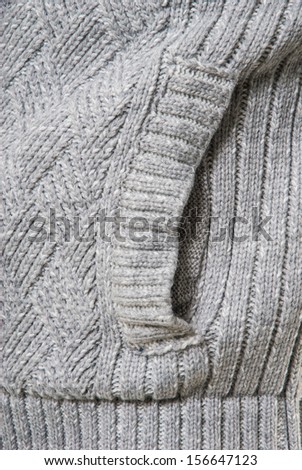 Young man in winter clothes getting cold.  picture of a male fashion model wearing wool sweater.  studio picture of a young man dressed for winter.