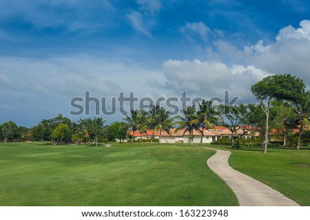 Golf Course in Tropical Paradise. Summertime holiday in Dominican Republic. Tropical Paradise. Dominican Republic, Caribbean, Mauritius, Philippines, Bahamas, Seychelles.  Pathway in tropical park.