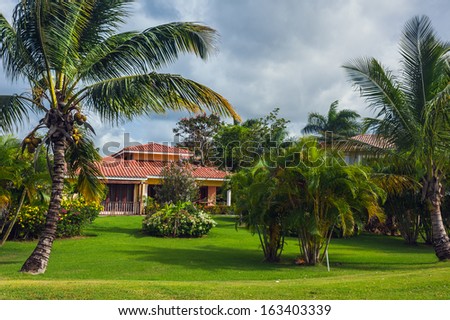 Luxurious villa in Dominican Republic. Beautiful villa with an own swimming pool. villa on luxury Caribbean resort with beautiful garden. Classical spanish villa among flowers, not far from ocean.