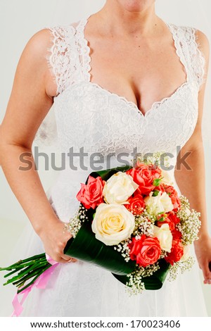 Beautiful wedding bouquet in hands of the bride. Bride with bouquet. bride holds bouquet of roses, closeup