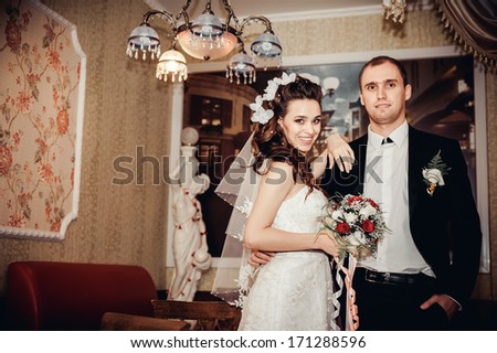 newly married couple in luxury hotel. Charming bride and groom on their wedding celebration in a luxurious restaurant. happy bride and groom in the modern hotel hall. interior of hotel in wedding day