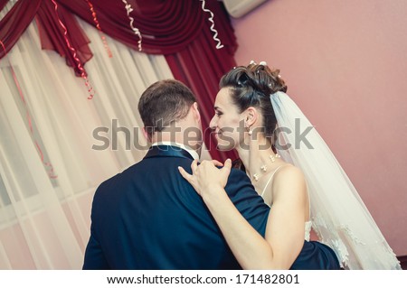 wedding dance of bride and groom. Kiss and dance young bride and groom in banqueting hall