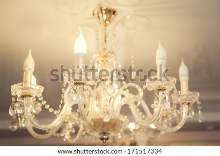 Chrystal chandelier close-up. Glamour background with copy space. Beautiful crystal chandelier detail close up