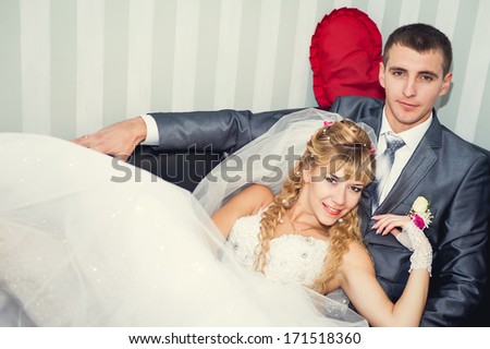 Cute married couple in cafe. romantic rest in vintage cafe interior. Charming bride and groom on their wedding celebration in a luxurious restaurant.