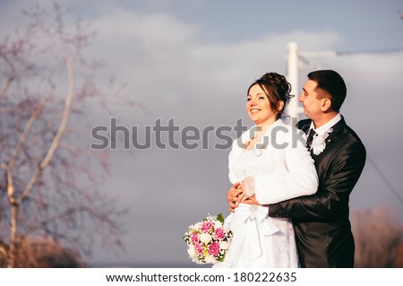 Happy bride and groom on their wedding in park. Bride and Groom at wedding Day walking Outdoors on spring nature. Bridal couple, Happy Newlywed woman and man embracing in green park.