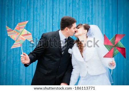 Wedding day outside. couple in love bride and groom with a bouquet at bridal day in summer. Enjoy a moment of happiness and love and having fun with funny false mustache. playful newlywed family