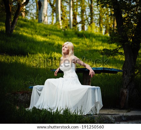 Beauty Girl Outdoors enjoying nature near the ancient castle. Beautiful Teenage Model girl in white dress on the Spring Field. bride enjoying walking in spring forest. Free Happy Woman.