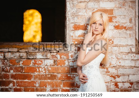 Beauty Girl Outdoors enjoying nature near the ancient castle. Beautiful Teenage Model girl in white dress on the Spring Field. bride enjoying walking in spring forest. Free Happy Woman.