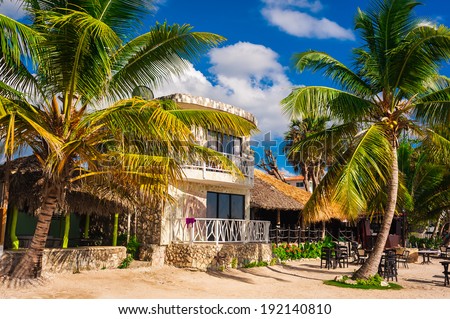 hut in a tropical jungle. jungle lodge. Tropical beach house in Dominican Republic. summertime vacation. tropical panoramic beach. native typical tropical island. caribbean life. boat on the beach