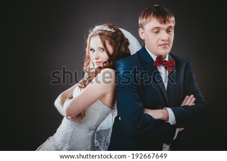 newly-married couple on the isolated black background. Affectionate bride and groom with head to head. Loving bride and groom
