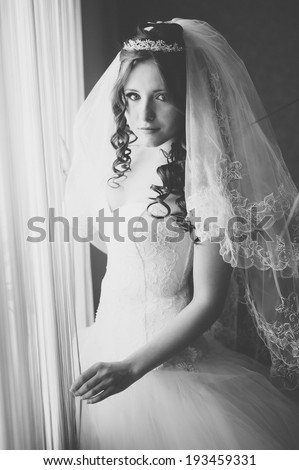 beautiful bride in white wedding dress with hairstyle and bright makeup. Happy sexy girl waiting for groom. Romantic lady in bridal dress have final preparation for wedding