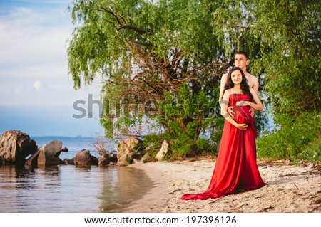 Portrait of beautiful loving couple awaiting baby. Husband and wife maternity expecting a child or baby