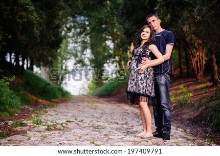 Portrait of beautiful loving couple awaiting baby. Husband and wife maternity expecting a child or baby